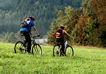 man-and-woman-biking-through-trail.